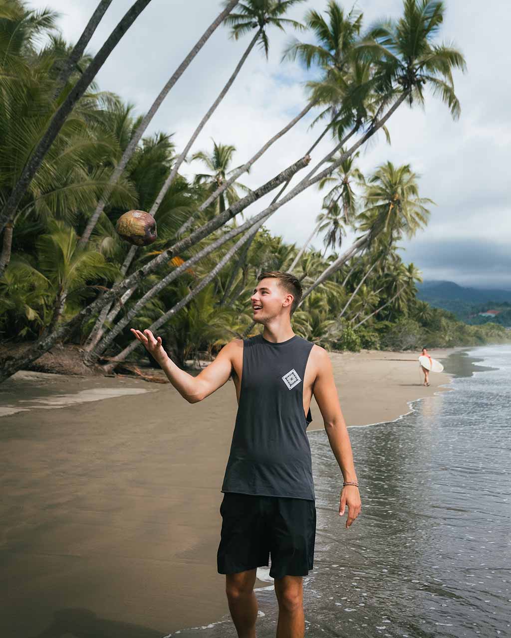 A person throwing a coconut on Uvita Beach in Costa Rica.