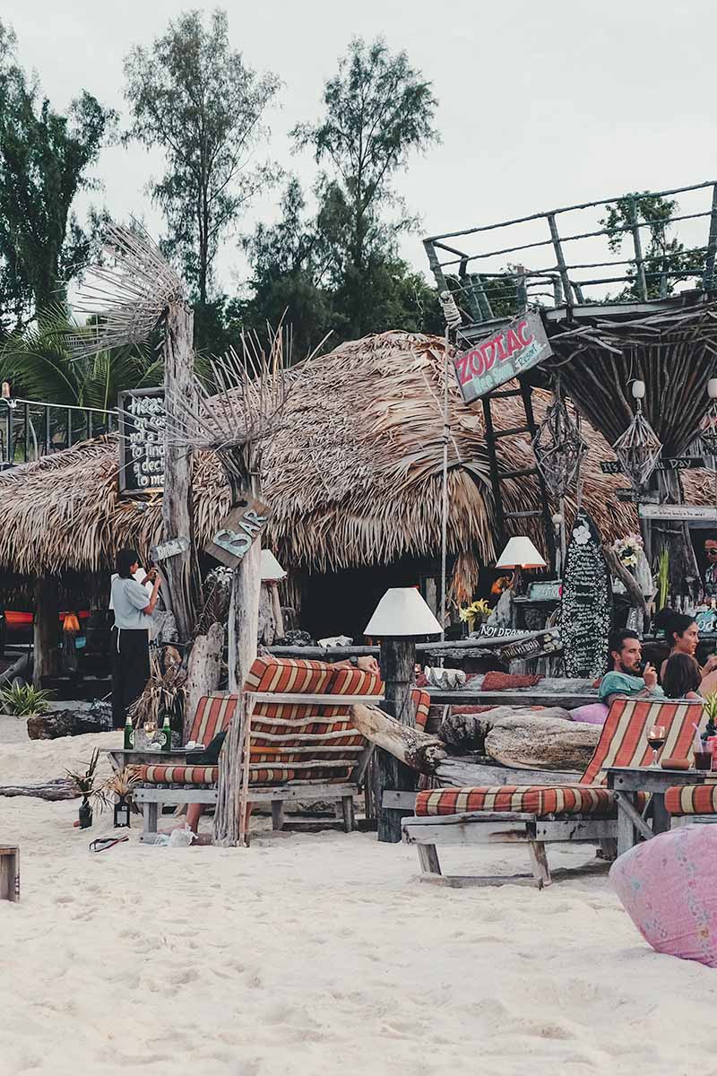 Zodiac Beach Club's wooden beach chairs and benches.