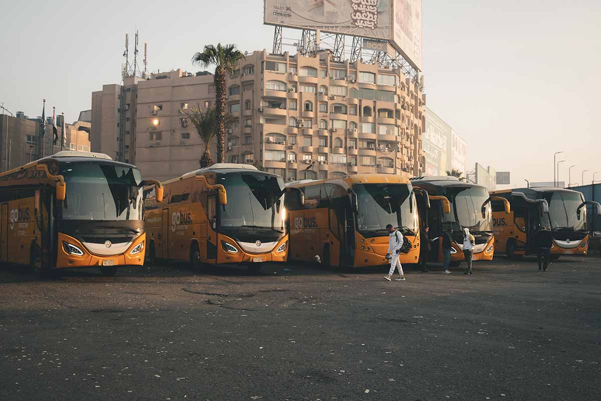 Five Gobus coaches parked in a row within the GoBus Tahrir Boarding Station in Cairo.