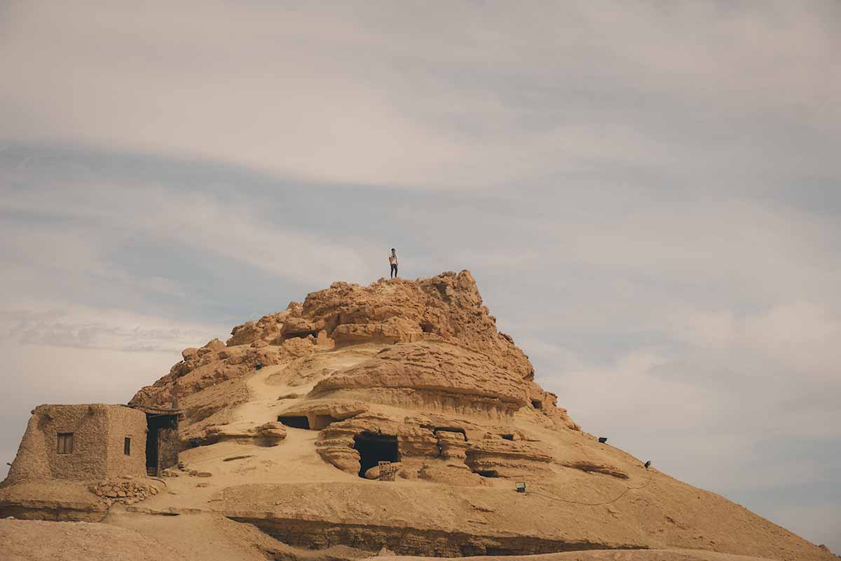 A person standing at the top of the Mountain of the Dead.