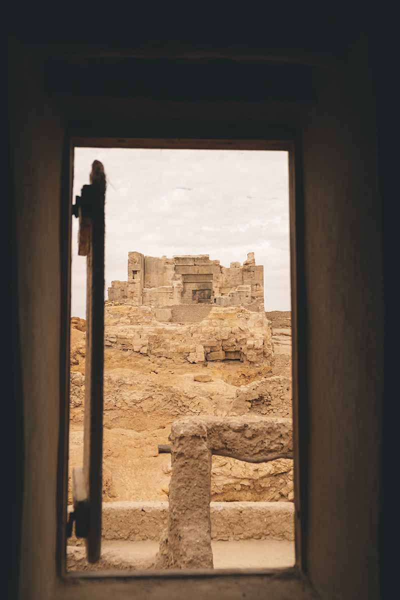 An open window that looks onto the inner temple and courtyard of the Oracle Temple.