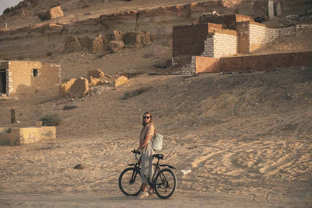 A woman stopped on her bike at the base of Dakrur Mountain.