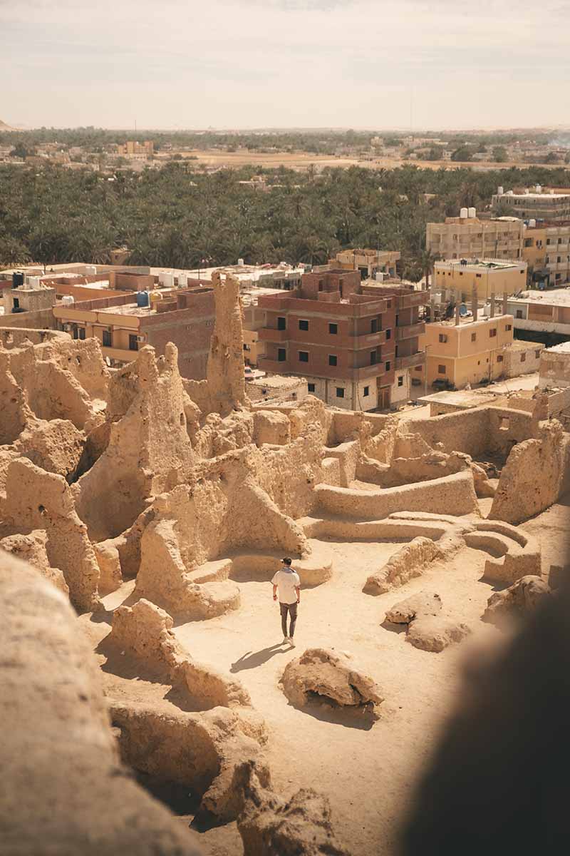 A birds-eye view of a tourist exploring the ruins of Shali Fortress.