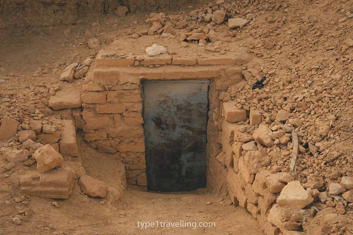 The closed entrance of an ancient tomb.