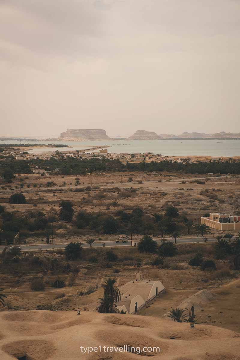 The view looking over a dry landscape and lake.