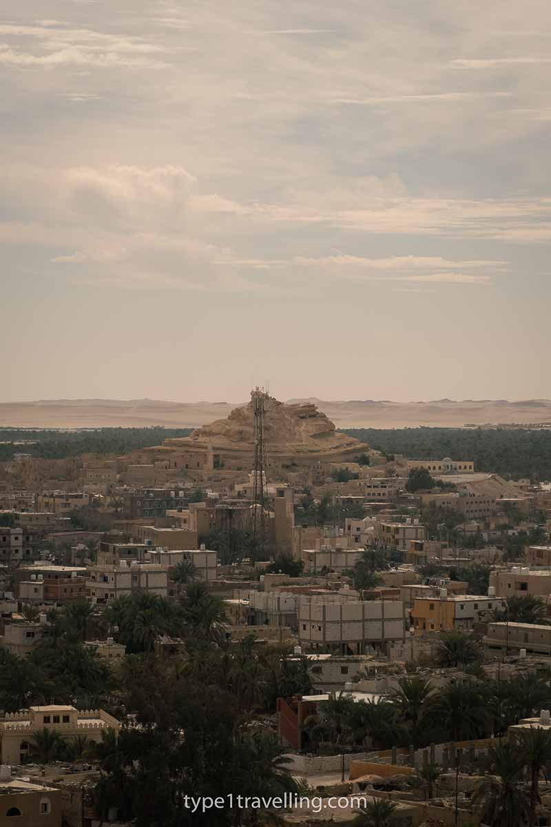 A view looking over Siwa town, Shali Fortress and distant desert sand dunes.