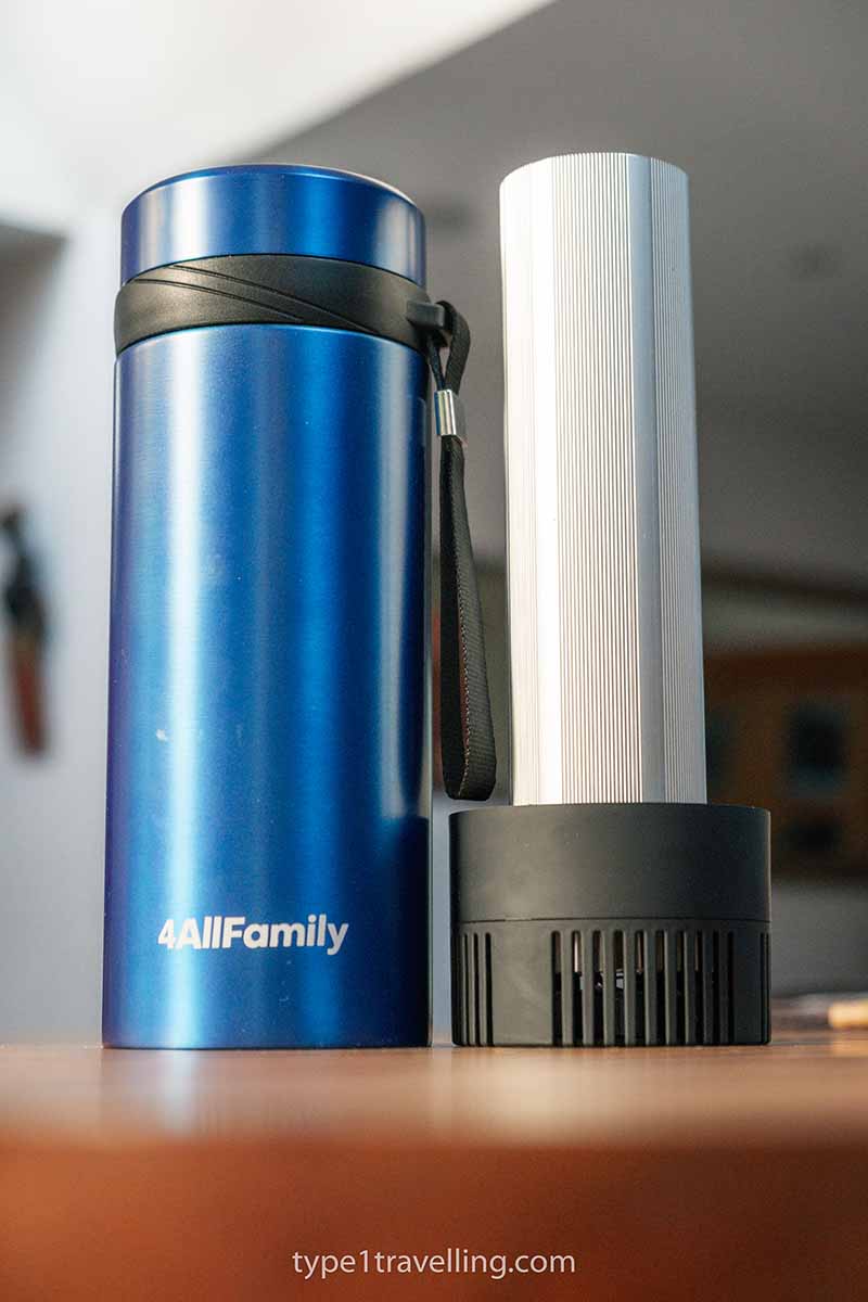 A blue 4ALLFAMILY Voyager travel fridge and USB lid displayed next to each other on a table.