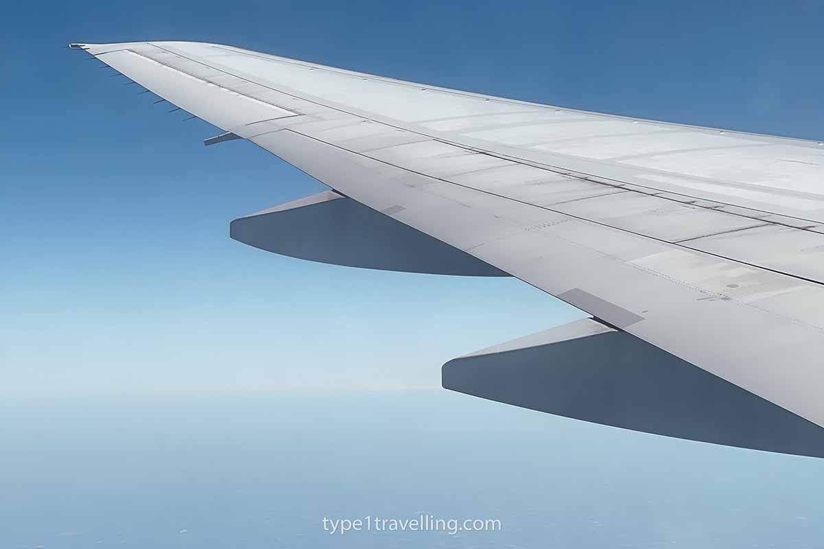 The wing of an airplane mid-flight.