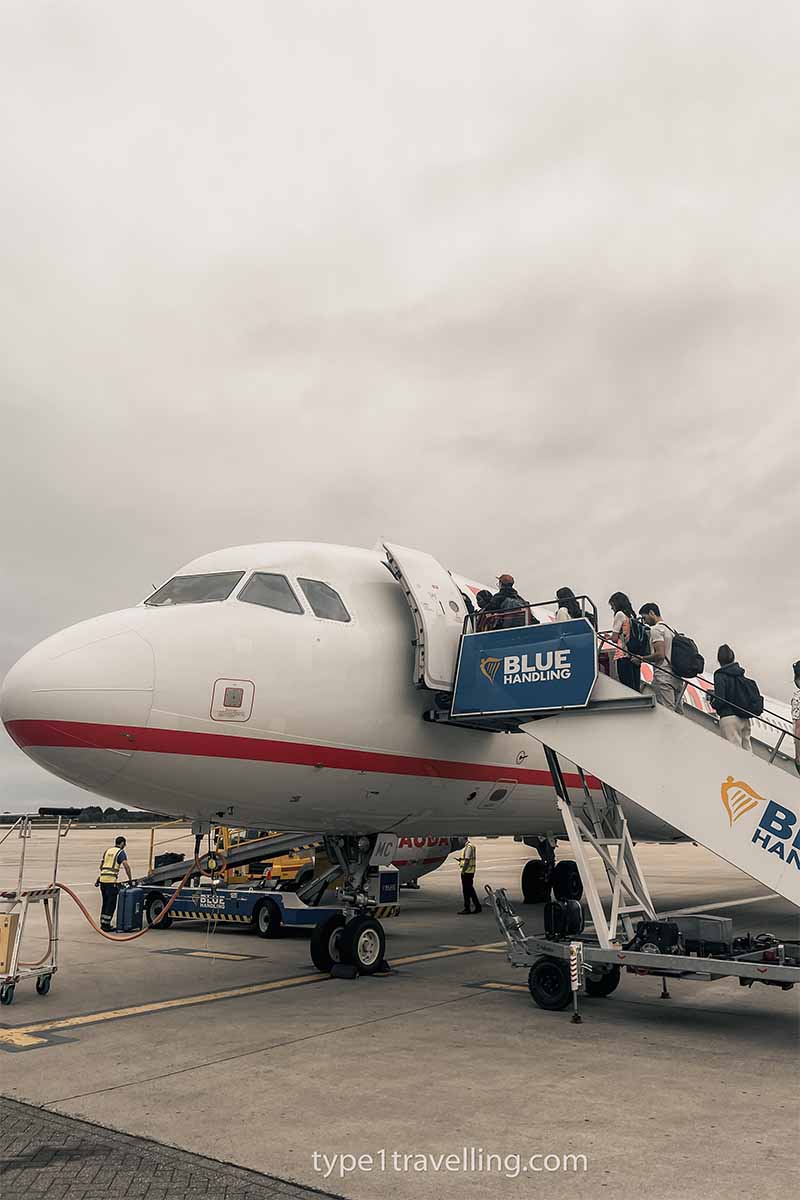 A group of people boarding a Ryanair aeroplane.