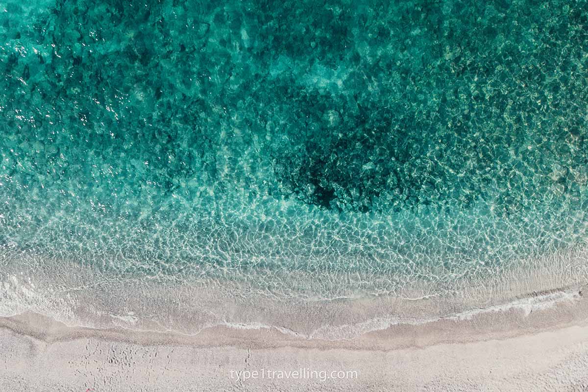 mirror-beach-water A drone view looking down on turquoise water breaking onto the shore of Mirror Beach.