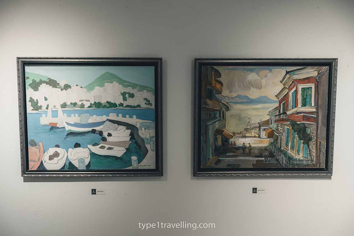 galeria-art-saranda Two paintings on the wall inside Galeria Art Saranda.