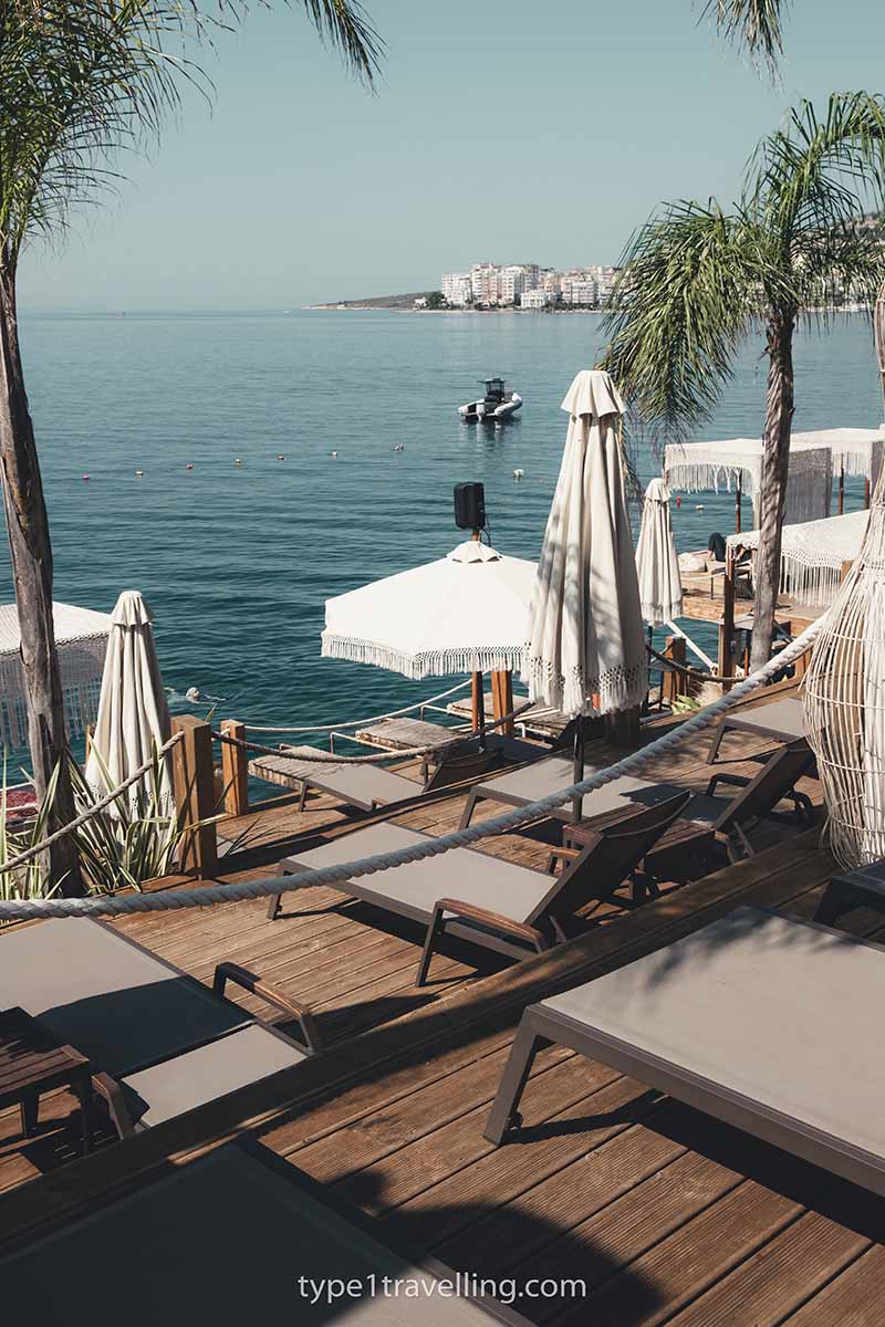 Empty sun loungers on the wooden terraces of Lost Seaside Beach Club.