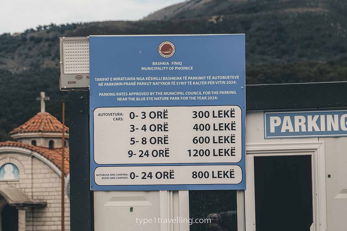 A sign displaying the parking rates for the car park of the Blue Eye Nature Park.