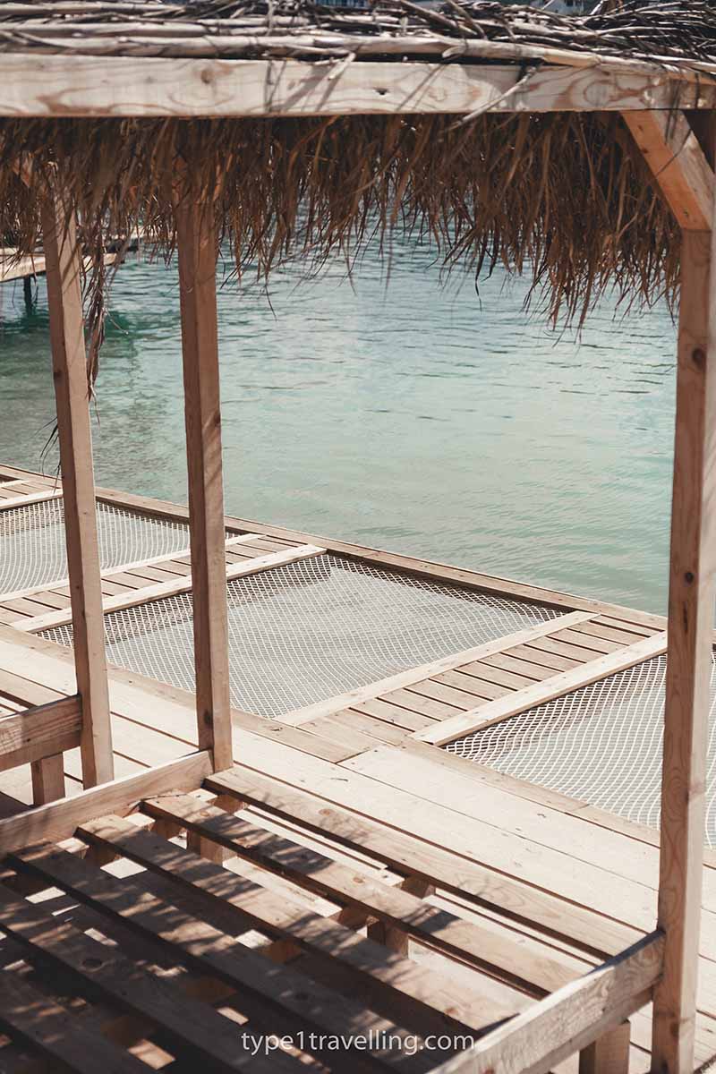 A line of beach cabanas and overwater nets at Puerto Rico Beach.