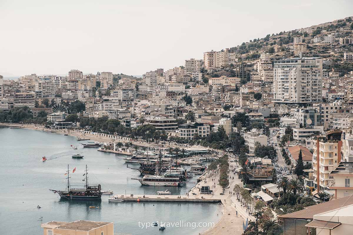 saranda-bay A view over Saranda Bay with sailboats docked at the promenade and apartment buildings spilling up the hill.