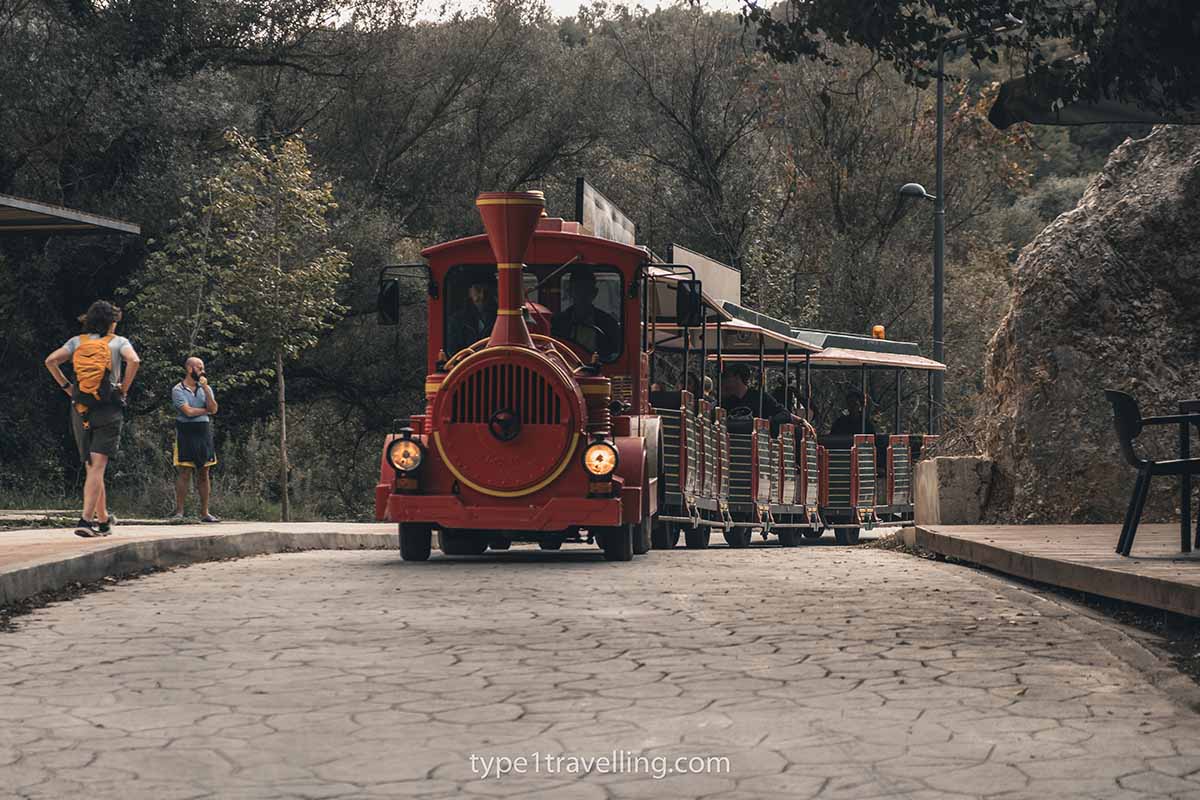 A tourist shuttle bus in the shape of a train transporting people to the Blue Eye.