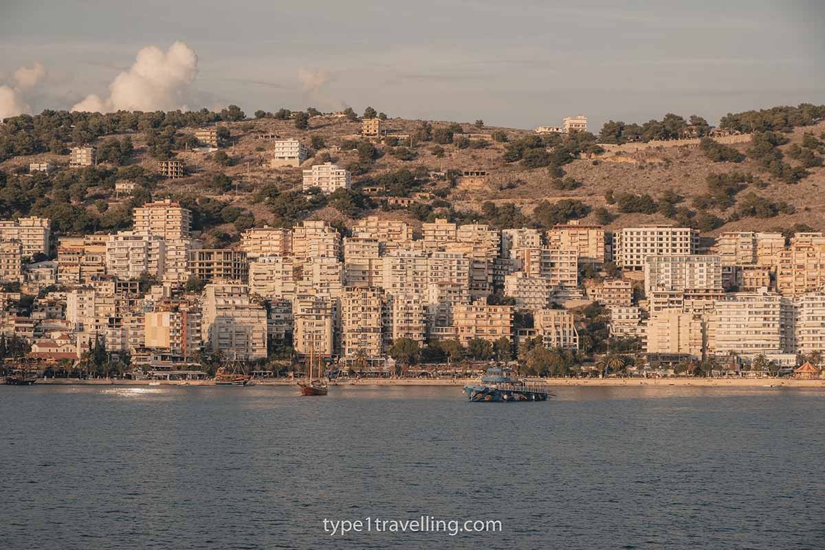 The bay of Saranda and its rows of high-rise apartment buildings as seen from a ferry which is coming into the city from Corfu.