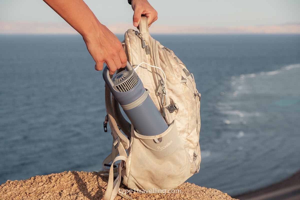 rxcoolers-max-model A hand pulling an RXCoolers Max travel fridge from the side pocket of a backpack.