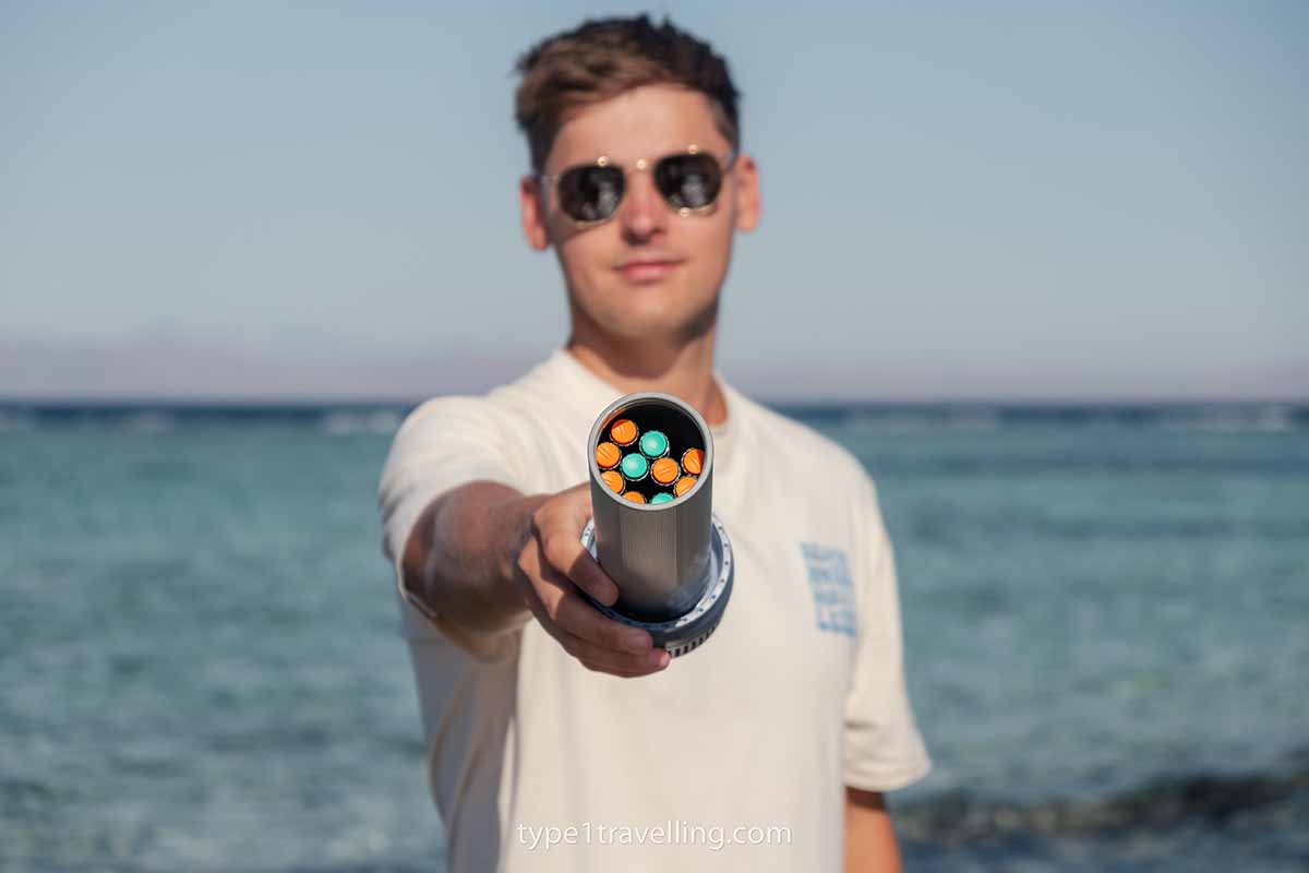 rxcoolers-max-usb-lid A man holding the USB lid of an RXCoolers Max showing the inner compartment of the cooling tube which is filled with insulin pens.