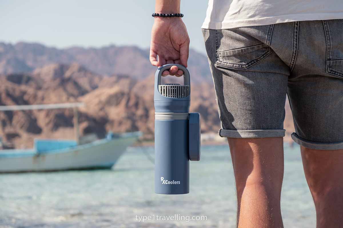 rxcoolers-max A person standing next to the sea while holding an RXCoolers Max by their side.