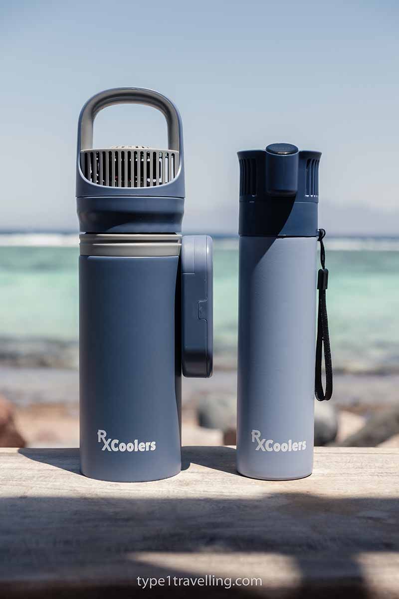 An RXCoolers Max and Mini model sitting next to each other on a wooden table with the sea in the background.