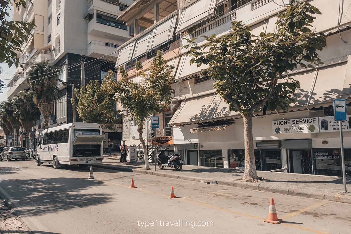 Four traffic cones blocking off the bus parking area at Saranda Bus Station.