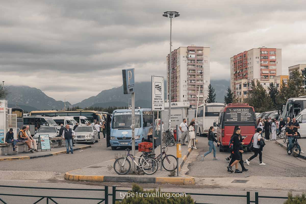 Tirana's South and North Bus Terminal busy with people and buses leaving and arriving.
