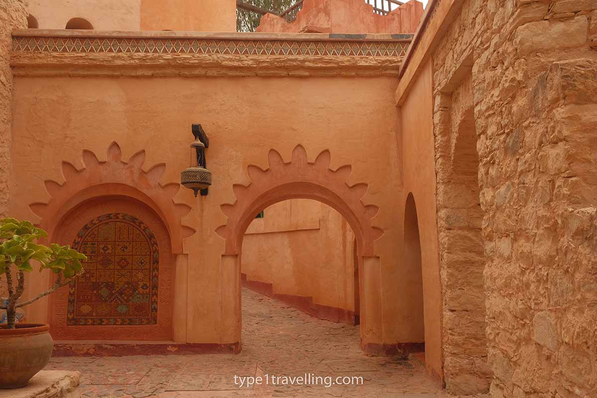 A detailed archway that leads to a cobbled alleyway in the Agadir Medina.