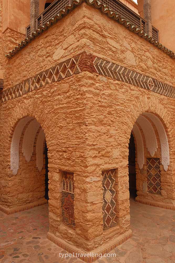 A detailed stone wall corner with two archways on either side.