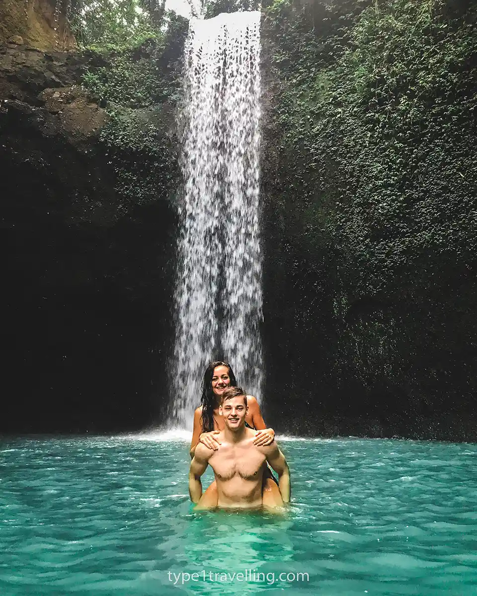 sam-and-lucy-bali Sam piggybacking Lucy in front of a waterfall in Bali.